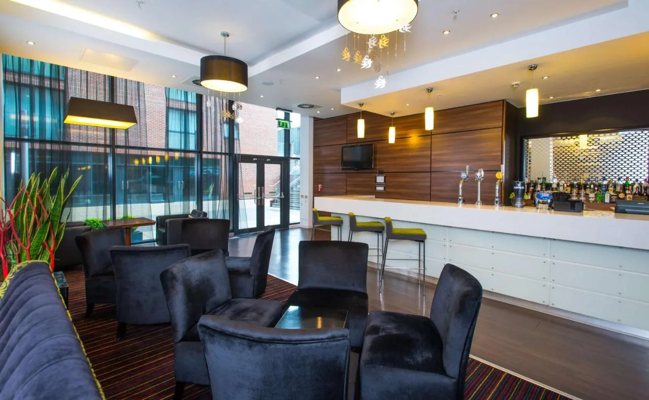 Restaurant with tables and a bar at Hampton by Hilton Liverpool City Centre