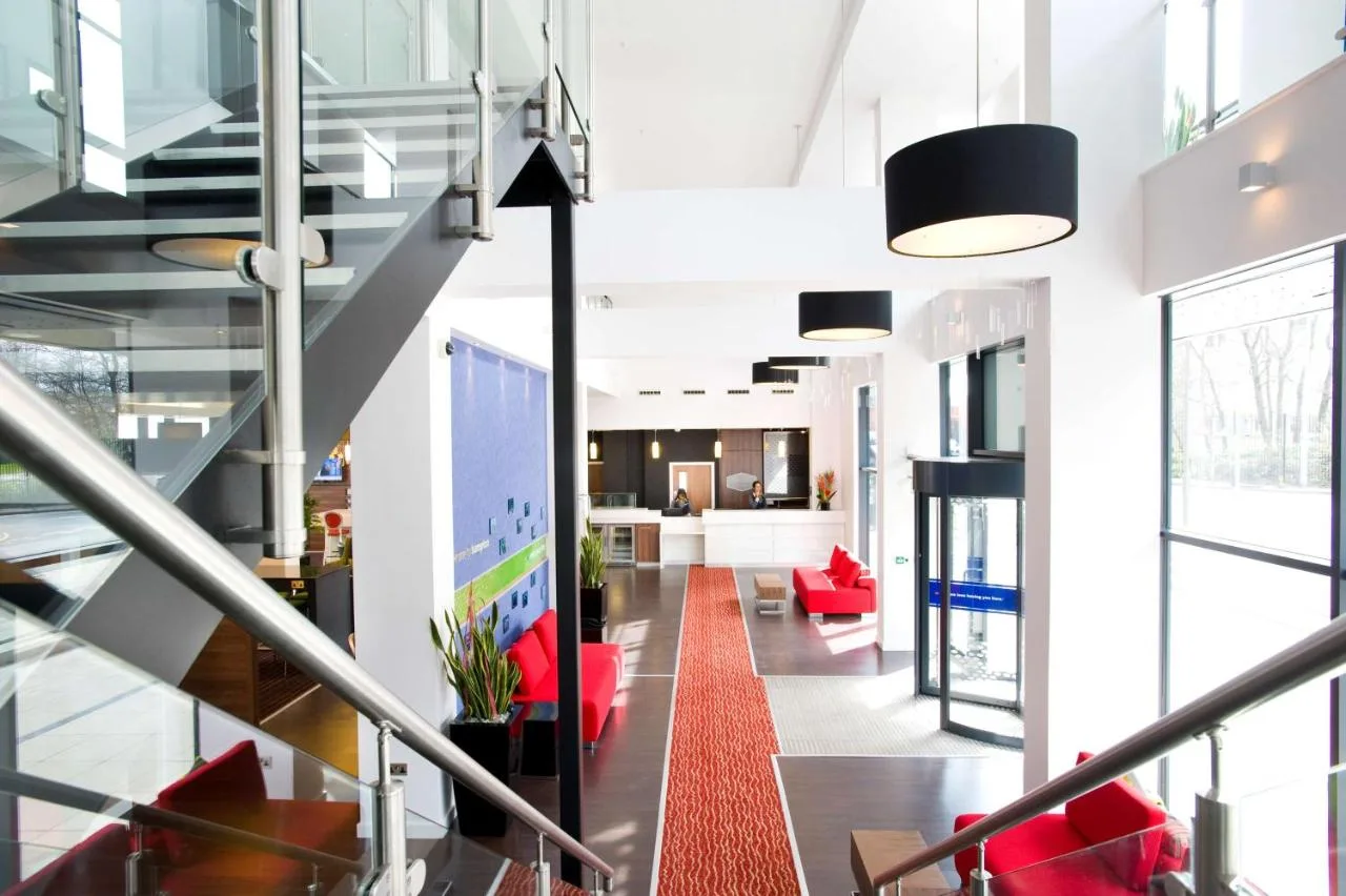 Hallway with red chairs and stairs inside the hotel